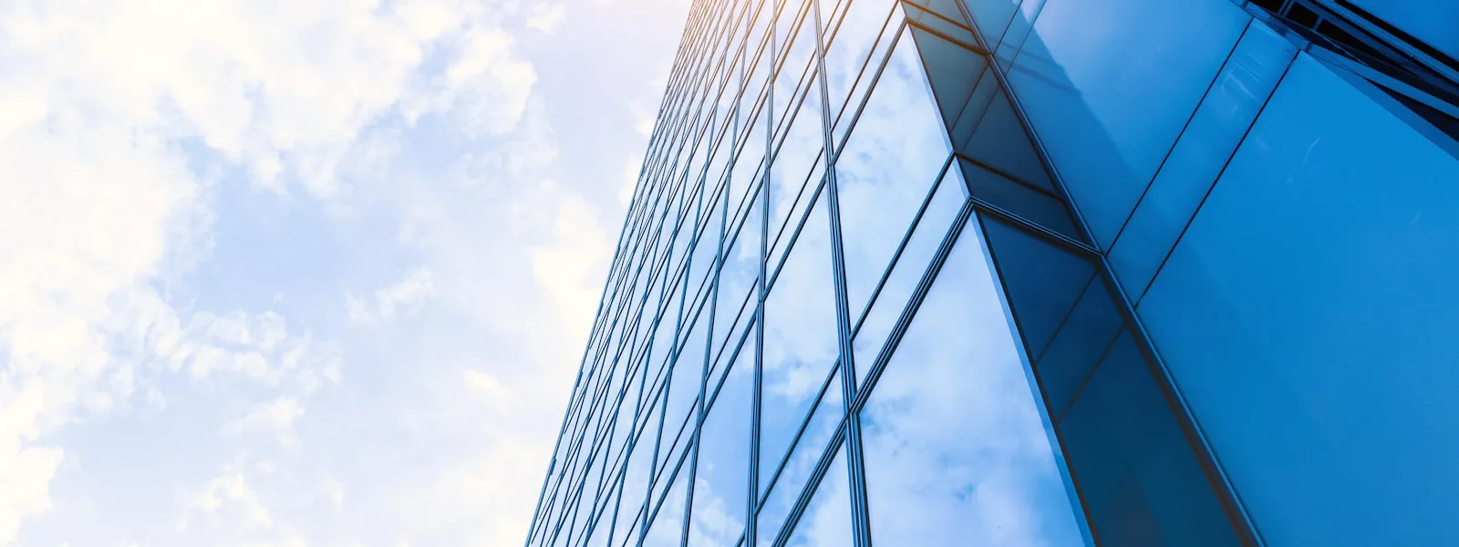 Glass-fronted high-rise building viewed from below — parent company data when applying for an LEI number